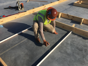 Clean Line Reveal rustication strips for Tilt-Up concrete construction Gluing down the Clean Line Reveal